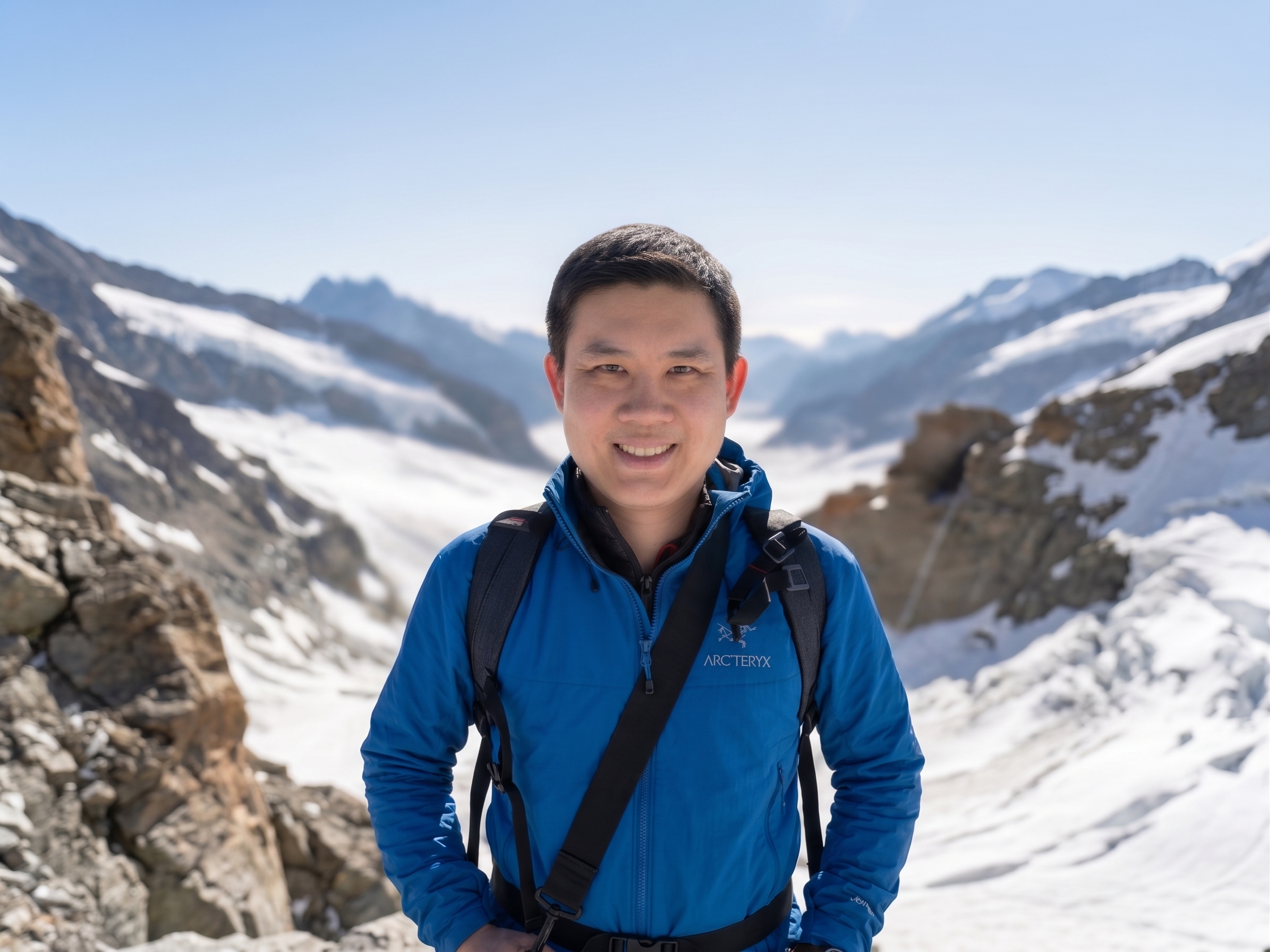 Chris Cheng smiling in the mountains